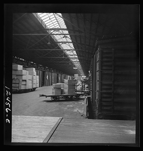 Untitled photo, possibly related to: Chicago, Illinois. Goods of every description on loading platforms in a yard waiting to be loaded into cars at the Chicago and Northwestern Railroad freight house