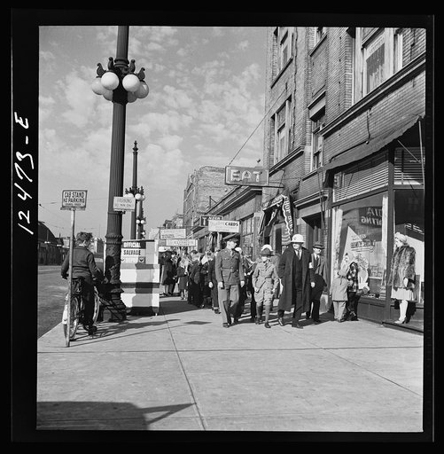 Chicago (north), Illinois. Parade, starting at Office of Civilian Defense headquarters before the dedication of a flag in memory of the men in the armed forces of the block