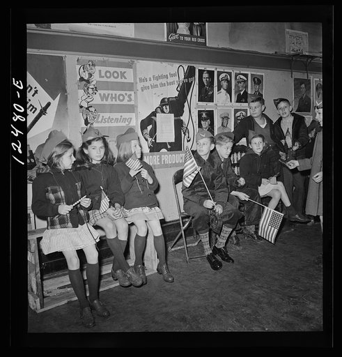 Chicago (north), Illinois. Children gathering in Office of Civilian Defense block headquarters to participate in a flag dedication ceremony