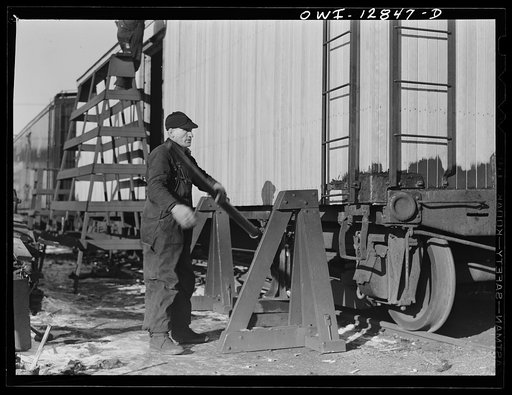 Chicago, Illinois. Jacking up a freight car which is being rebuilt at the rip tracks at a Chicago and Northwestern Railroad