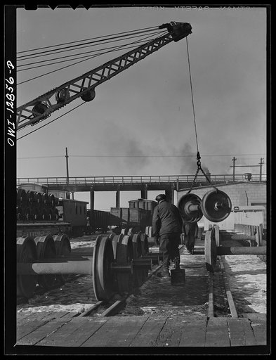 Chicago, Illinois. Unloading car wheels just arrived from the repair shops at the rip tracks of the Chicago and Northwestern Railroad