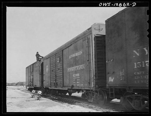 Chicago, Illinois. Switchmen riding a car at a Chicago and Northwestern Railroad yard