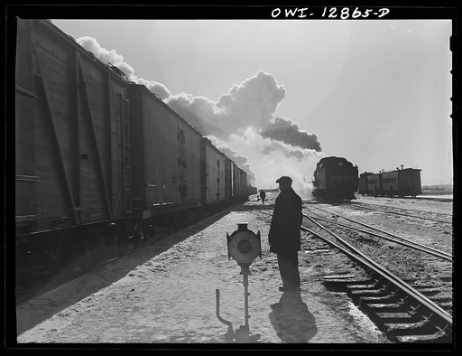 Chicago, Illinois. Yardmaster watching a train pulling out of one of the Chicago and Northwestern Railroad