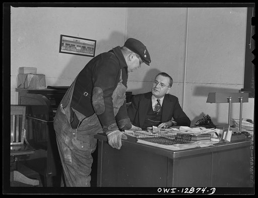 Chicago, Illinois. Mr. J.F. Kohaut (right), assistant agent in charge of the freight house discussing a freight loading with a foreman at a Chicago and Northwestern Railroad yard