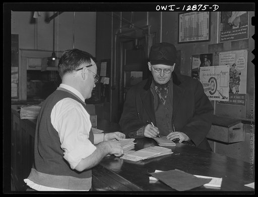Chicago, Illinois. Conductor John L. Walter getting his waybills before leaving a Chicago and Burlington railroad yard for Clinto, Iowa
