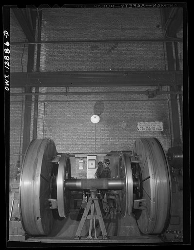 Chicago, Illinois. Worn tires on locomotive wheels are refaces on this machine in the wheel shop of the Chicago and Northwestern Railroad