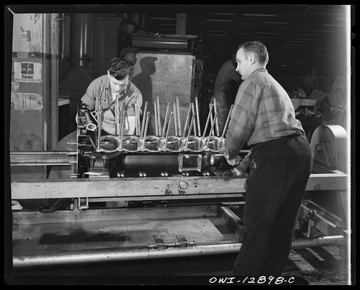 Detroit, Michigan. Assembly of Rolls Royce engines at the Packard motor car company. Driving cylinder hold down into the upper crank case