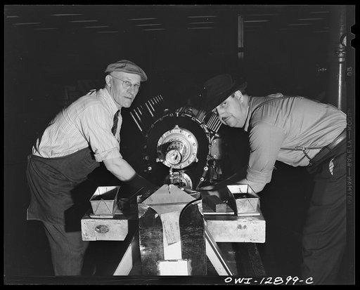 Detroit, Michigan. Assembly of Rolls Royce engines at the Packard motor car company. Final installation of the gear housing