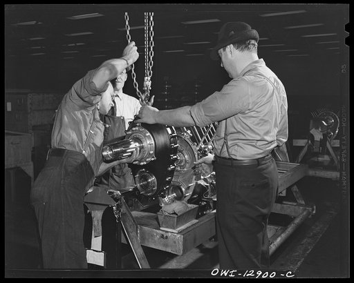 Detroit, Michigan. Assembly of Rolls Royce engines at the Packard motor car company. Attaching the gear housing to one crankcase