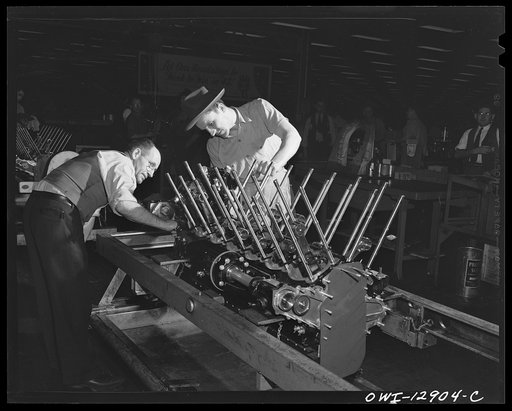 Detroit, Michigan. Assembly of Rolls Royce engines at the Packard motor car company. Inspection prior to installation of the reduction gear housing