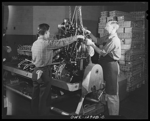 Detroit, Michigan. Assembly of Rolls Royce engines at the Packard motor car company. Assembling a super charger into an engine assembly