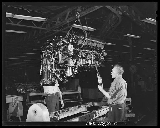 Detroit, Michigan. Assembly of Rolls Royce engines at the Packard motor car company. Hoisting a complete engine from a conveyor dolly