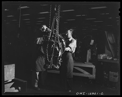 Untitled photo, possibly related to: Detroit, Michigan. Assembly of Rolls Royce engines at the Packard motor car company. Dropping engine on a horse before weighing it