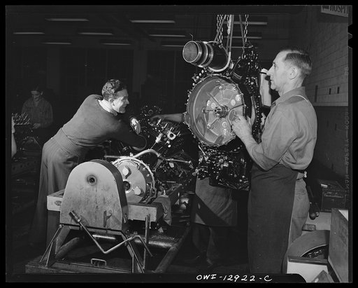 Detroit, Michigan. Assembly of Rolls Royce engines at the Packard motor car company. Assembling a super charger into an engine assembly