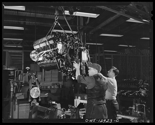 Detroit, Michigan. Assembly of Rolls Royce engines at the Packard motor car company. Dropping engine on a horse before weighing it