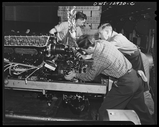 Detroit, Michigan. Assembly of Rolls Royce engines at the Packard motor car company. Assembling a super charger into an engine assembly