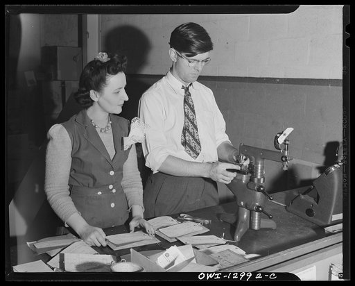 Detroit, Michigan. Assembly of Rolls Royce engines at the Packard motor car company. Checking threads with an amplifier