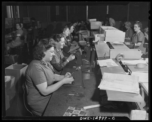 Detroit, Michigan. Assembly of Rolls Royce engines at the Packard Motor Car Company. Checking studs and bolts with dial indicators
