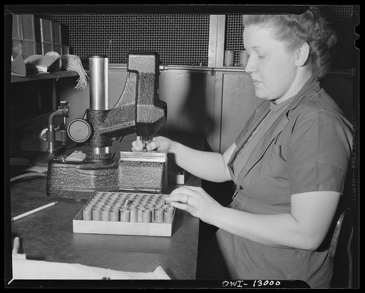 Detroit, Michigan. Assembly of Rolls Royce engines at the Packard Motor Car Company. Checking bushings by means of a shadow graph and an indicator