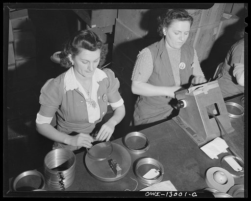 Detroit, Michigan. Assembly of Rolls Royce engines at the Packard Motor Car Company. Inspecting piston rings for flatness and uniformity of thickness