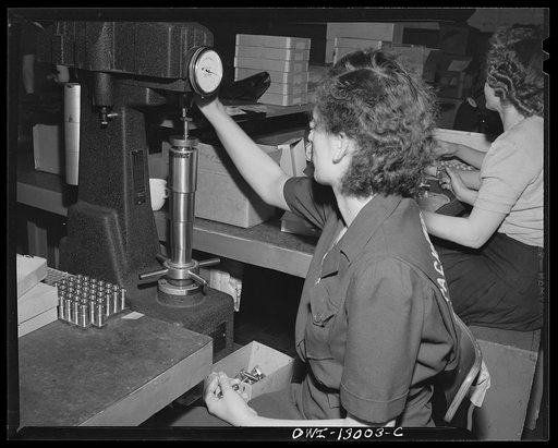Detroit, Michigan. Assembly of Rolls Royce engines at the Packard Motor Car Company. Rockwell hardness tester testing hardness of metal in a bolt