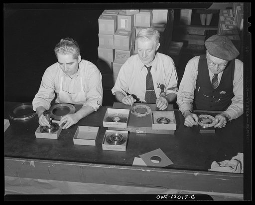 Detroit, Michigan. Assembly of Rolls Royce engines at the Packard Motor Car Company. Inspecting various parts of super charger clutch assemblies. These old men were never before employed in automobile plants
