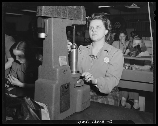 Detroit, Michigan. Assembly of Rolls Royce engines at the Packard Motor Car Company. Checking hardness of valve stem tip by means of Rockwell hardness tester