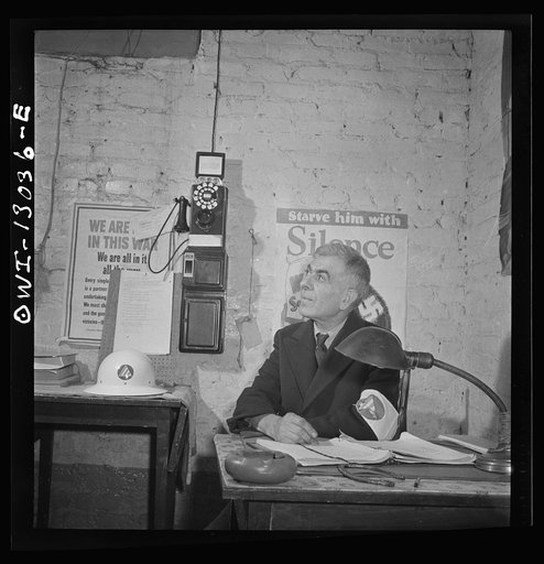New York, New York. Italian-American shoemaker on duty as an air raid warden at sector headquarters on Waverly Place
