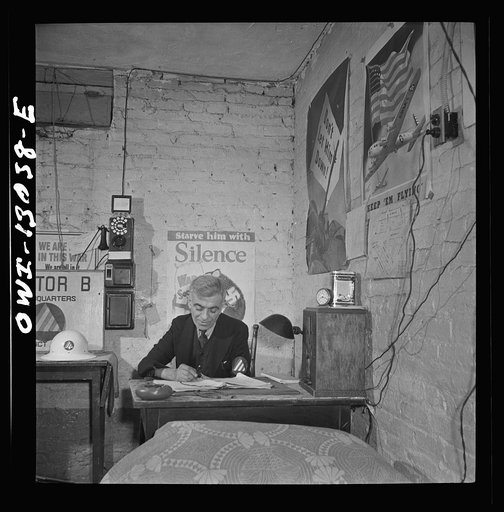 New York, New York. Italian-American shoemaker on duty as an air raid warden at sector headquarters on Waverly Place