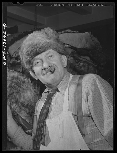 New York, New York. The War Emergency Board of the fur industry formed a fur vest project. Various fur factories donate the services of their employees one day a week to make fur-lined vests for the merchant marines. The fur is all from voluntary donations from the public. Jewish fur worker wearing 