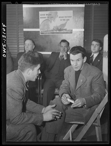 Untitled photo, possibly related to: New York, New York. Merchant seamen's Christmas party at the Andrew Feruseth Club on Christmas Day. Merchant seamen swapping stories. One, (left), had been torpedoed twice