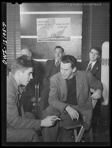 New York, New York. Merchant seamen's Christmas party at the Andrew Feruseth Club on Christmas Day. Merchant seamen swapping stories. One, (left), had been torpedoed twice
