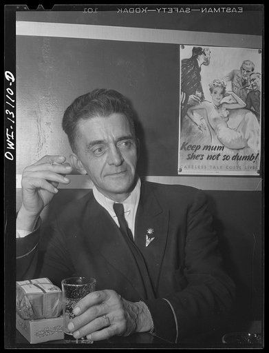 New York, New York. Merchant seamen's Christmas party at the Andrew Feruseth Club on Christmas Day. An old timer, a petty officer, having a beer at the bar. Every seaman got a present; his is still unopened