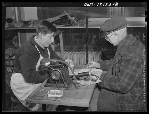 New York, New York. The War Emergency Board of the fur industry formed a fur vest project. Various fur factories donate the services of their employees one day a week to make fur-lined vests for the merchant marine. Expressman who has just brought in a new shipment of fur coats, going over receipts 