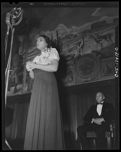 Untitled photo, possibly related to: Washington, D.C. Marian Anderson broadcasting a Negro spiritual at the dedication of a mural installed in the United States Department of the Interior building, commemorating the outdoor concert which she gave at the Lincoln Memorial after the Daughters of the Am