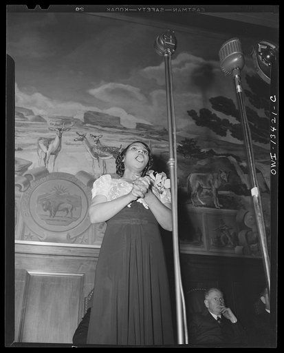 Washington, D.C. Marian Anderson broadcasting a Negro spiritual at the dedication of a mural installed in the United States Department of the Interior building, commemorating the outdoor concert which she gave at the Lincoln Memorial after the Daughters of the American Revolution refused to allow he