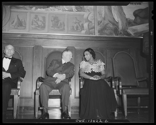 Washington, D.C. Marian Anderson broadcasting a Negro spiritual at the dedication of a mural installed in the United States Department of the Interior building, commemorating the outdoor concert which she gave at the Lincoln Memorial after the Daughters of the American Revolution refused to allow he