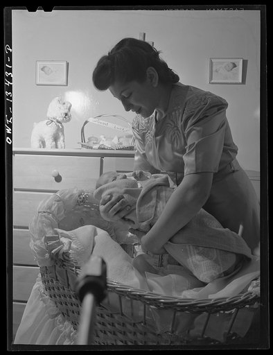 New York, New York. Mrs. Frank Romano and her month-old baby in their apartment on East Fourth Street and Second Avenue. Her husband works in the Brooklyn Navy Yard