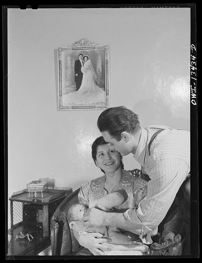 New York, New York. Mr. and Mrs. Frank Romano feeding their baby. He works in the Brooklyn Navy Yard