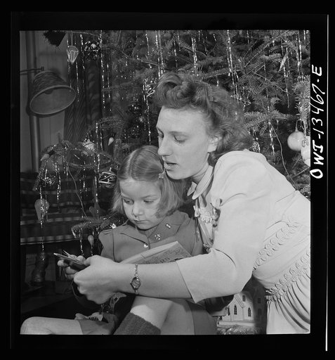 Untitled photo, possibly related to: New York, New York. Martinetti grandchild and her aunt at the Christmas tree. The pin indicates that her uncle is in the United States Army
