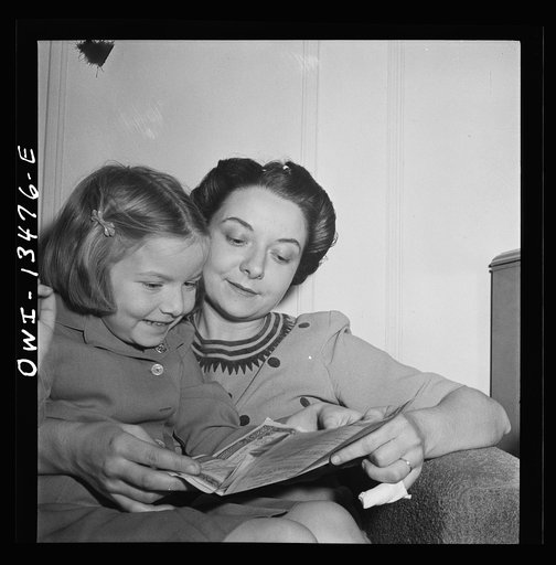 New York, New York. Martinetti's daughter and granddaughter examining a bond the child received for Christmas