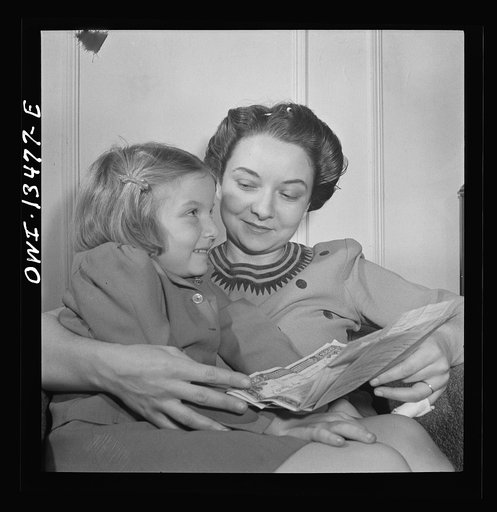 Untitled photo, possibly related to: New York, New York. Martinetti's daughter and granddaughter examining a bond the child received for Christmas