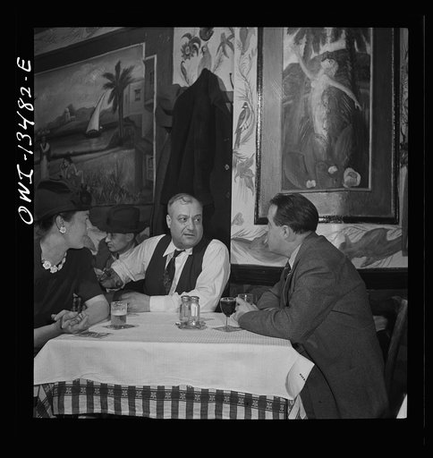 New York, New York. Jo Levy, owner of a Turkish nightclub on Allen Street, talking with guests