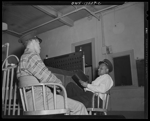 Washington, D.C. Firehouse Station No. 4. Probation fireman being questioned by Lieutenant Mills, to see if he is ready to go before the examination board