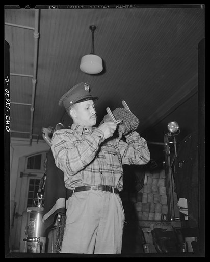 Washington, D.C. Firehouse Station No. 4. Probation fireman learning to use the apparatus used in fire fighting