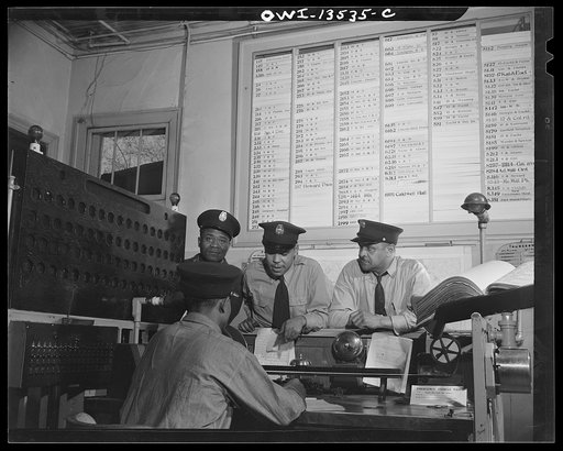 Washington, D.C. Firehouse Station No. 4. When an alarm is sounded, the men gather around the control desk and watch the 'joker' which indicates whether or not they go to the fire box pulled