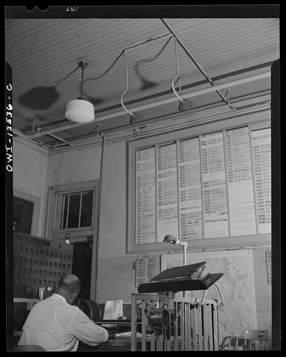Untitled photo, possibly related to: Washington, D.C. Firehouse Station No. 4. When an alarm is sounded, the men gather around the control desk and watch the 'joker' which indicates whether or not they go to the fire box pulled
