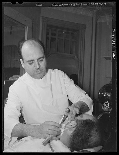 New York, New York. Barber in Vincent's barber shop on West Eighth Street
