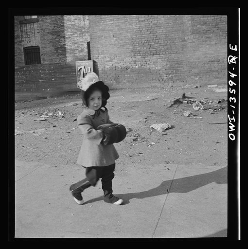 New York, New York. Child on Mott Street on Sunday