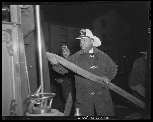 Washington, D.C. Firehouse Station No. 4. Lieutenant Mills pulling the main fire fighting hose from the truck so that it can be hooked to the nearest hydrant